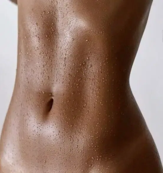 Close-up of a toned midriff with glowing skin