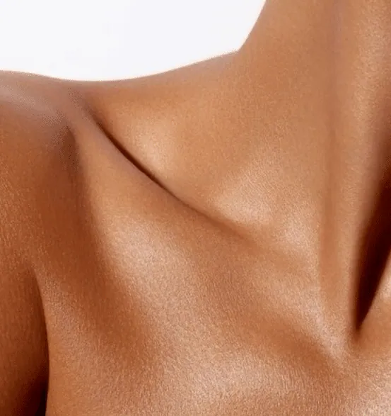 Close-up of a woman’s collarbone and shoulder