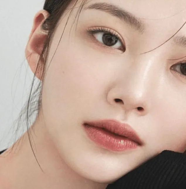 Close-up of a woman's face with clear, luminous skin