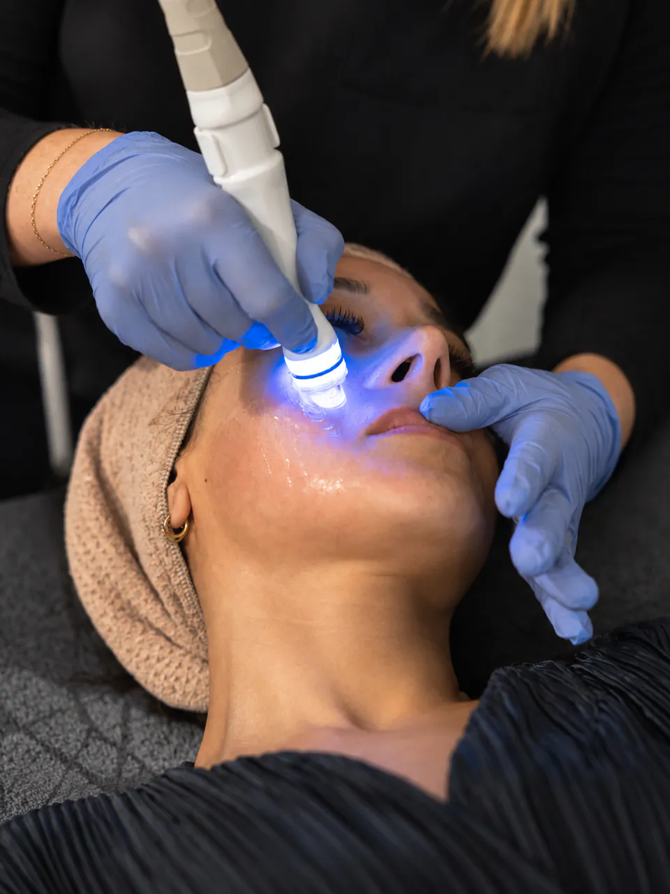 Close view of the Aquapure handpiece working across a client's cheek
