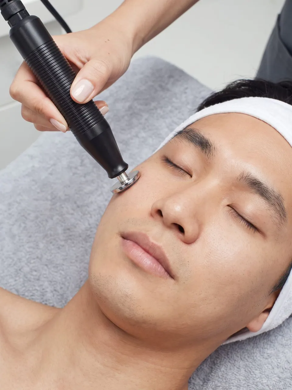 Close view of the sonic probe working actives into a patient's cheek
