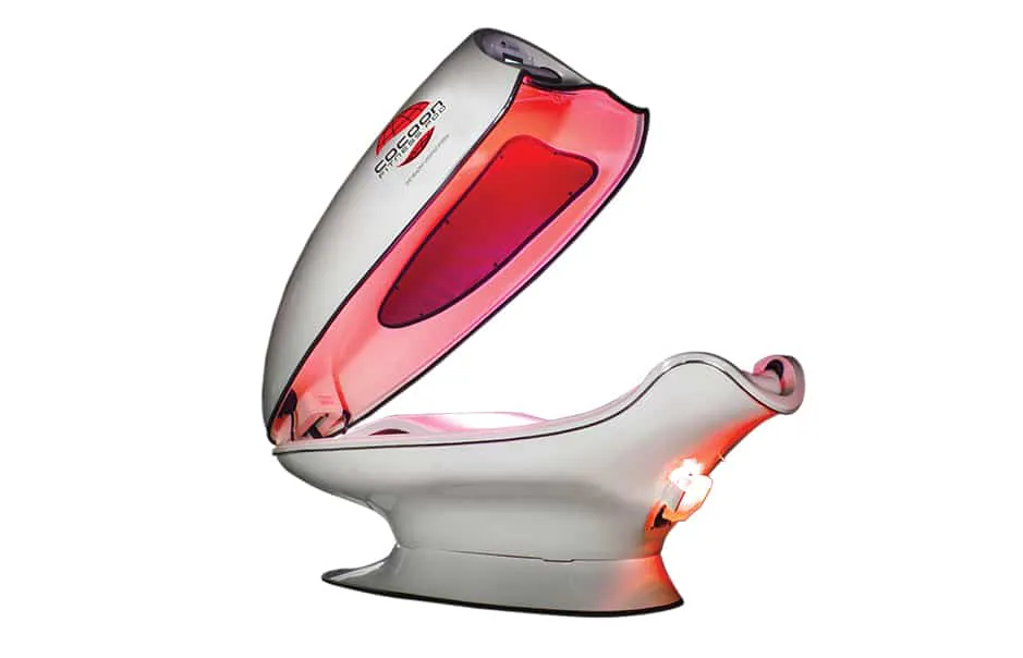 The Cocoon Wellness Pod, open, with its red interior lighting