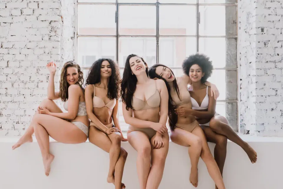 Women of different ethnicities sitting in front of the window
