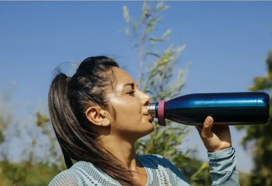 Woman drinking water from a bottle