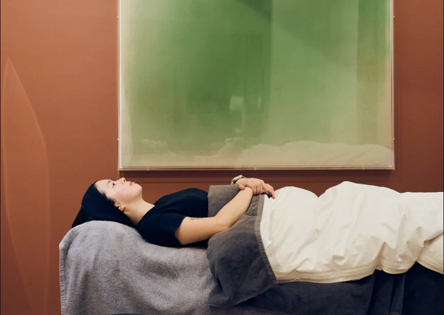 A patient resting on the treatment couch in the clinic's terracotta room