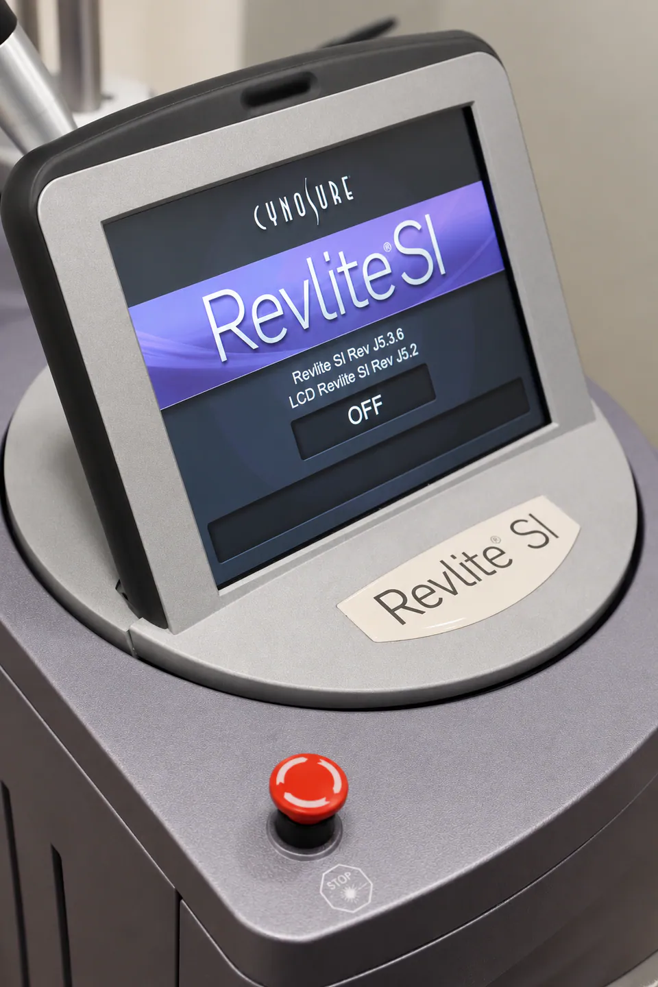 The RevLite SI console screen and emergency stop on the top of the laser platform